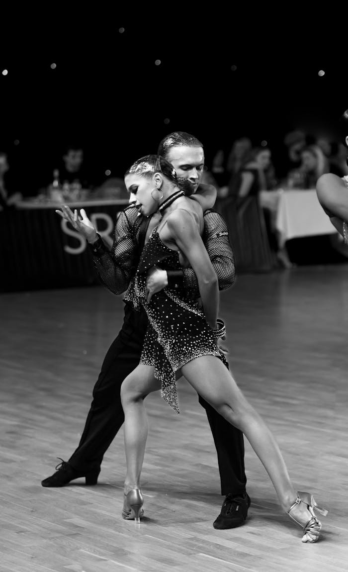 A couple performing an elegant ballroom dance with passion and grace.